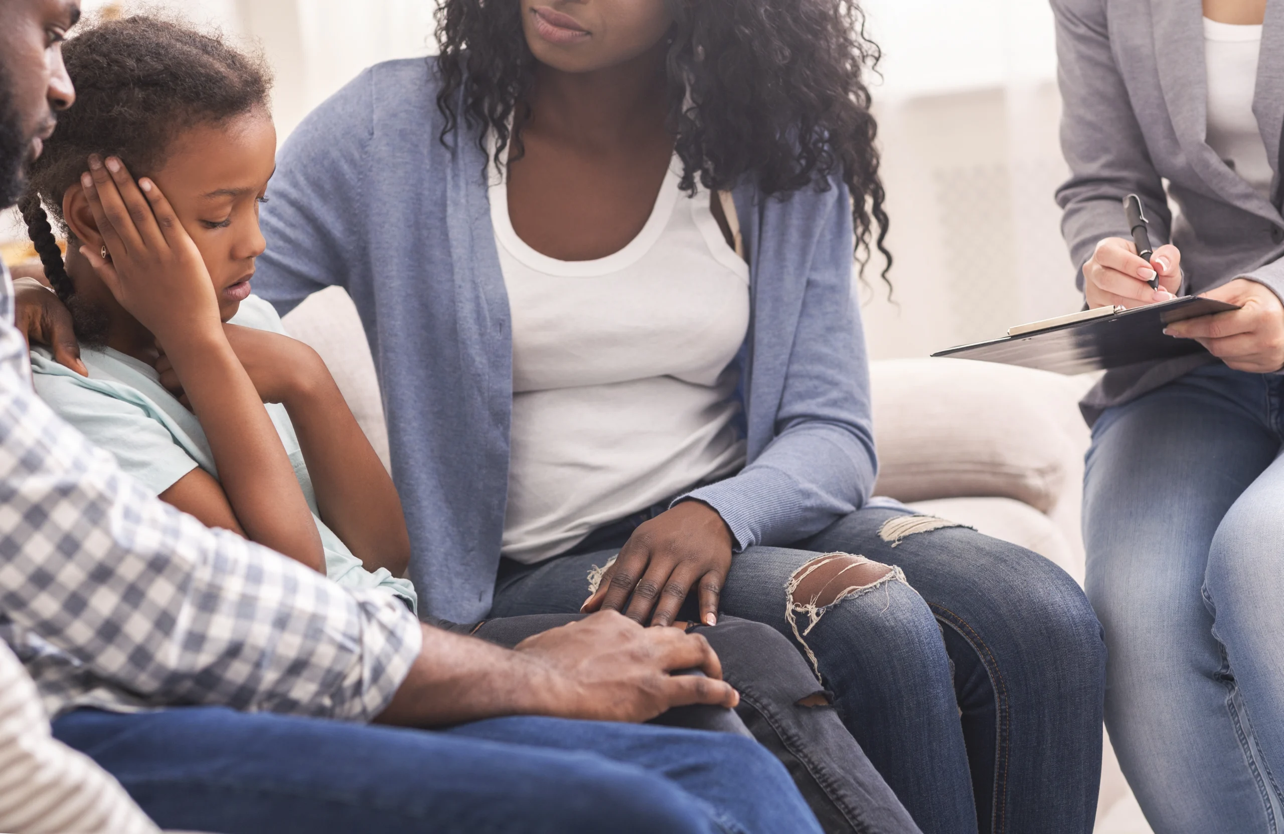 Parent calmly responding to upset child, showing emotional control and breaking generational trauma patterns