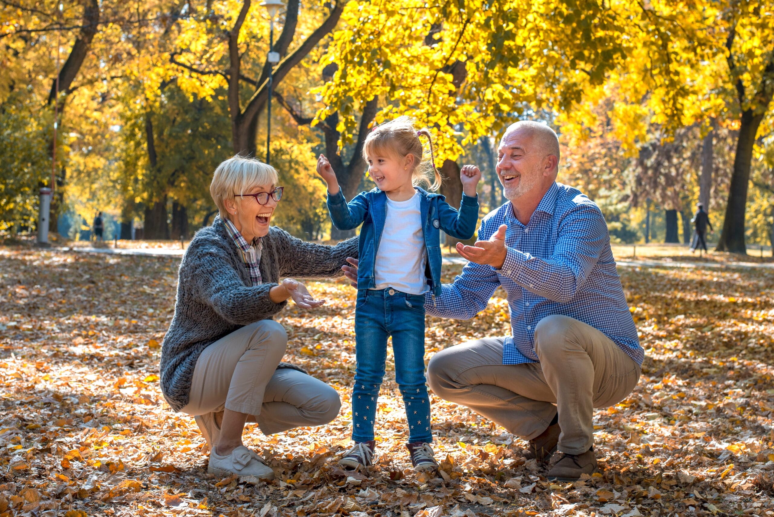 Closeup shot of smiling grandparents playing with their female grandchild presents 3 day reset for grandparents
