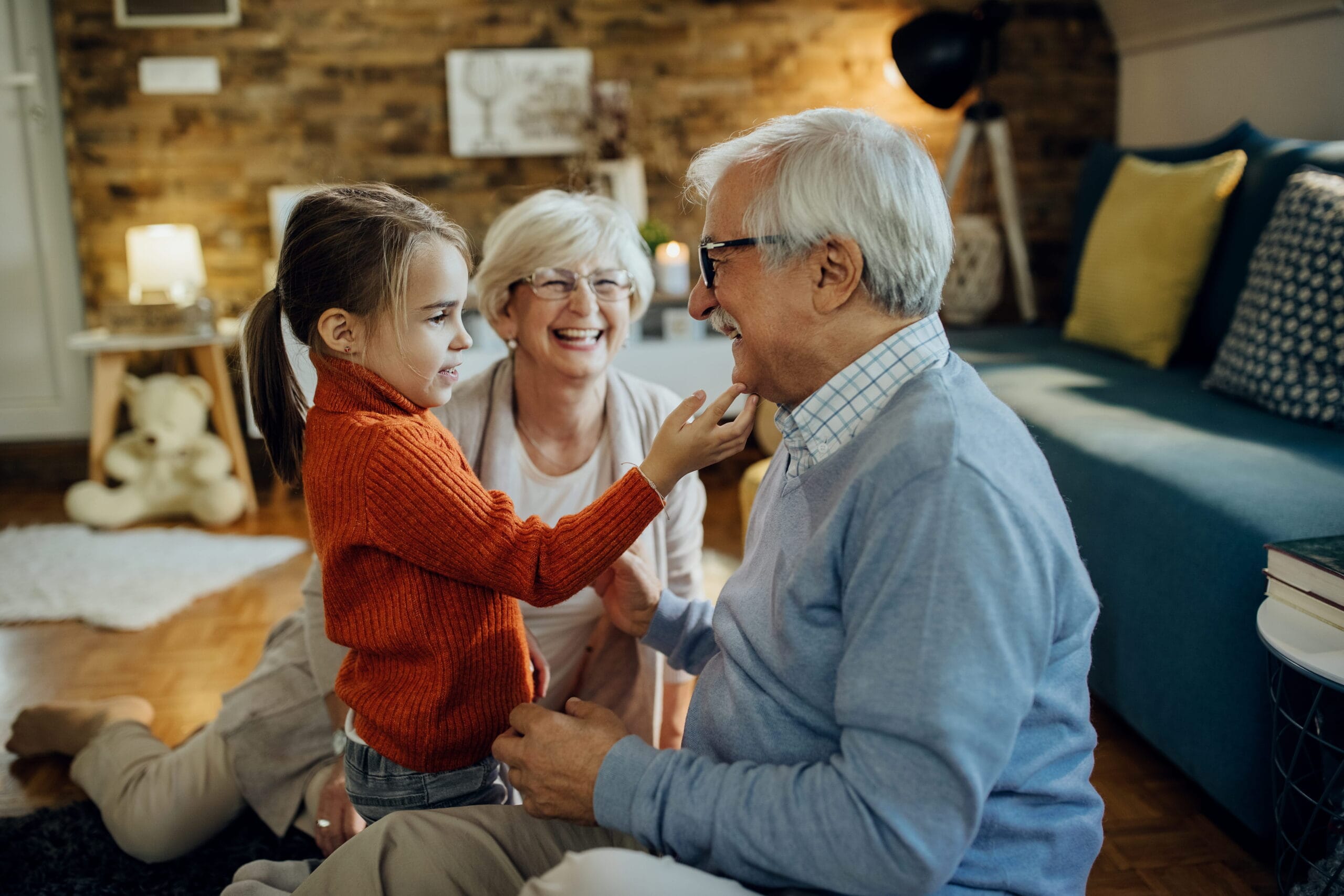 Cute small girl spending time with her grandparents at home presenting secondary trauma grandparents raising grandchildren